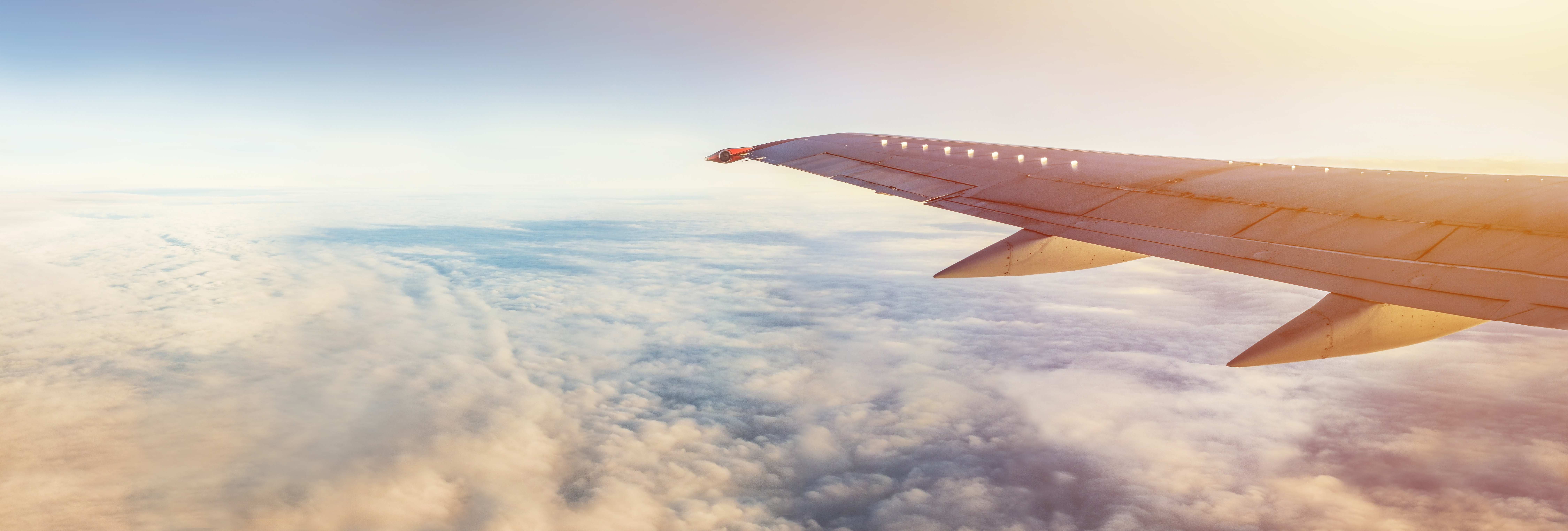 Airplane wing over sky